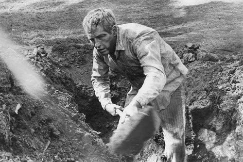 Paul Newman as Luke Jackson shoveling dirt in the movie Cool Hand Luke