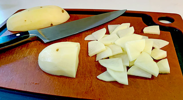 Sliced potatoes on a cutting board